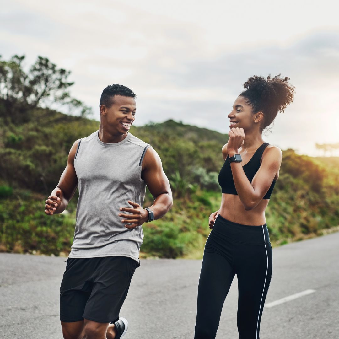 couple running down a road